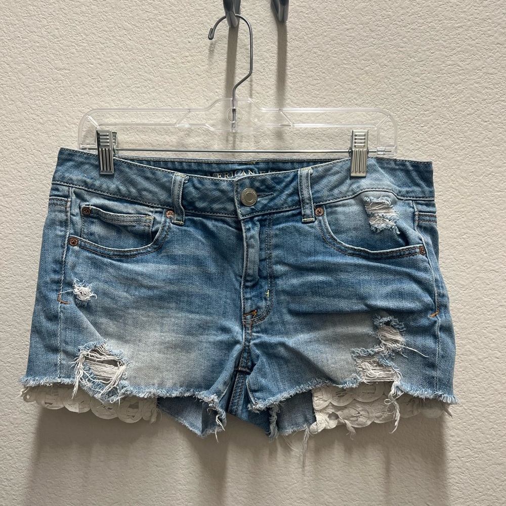 American Eagle light wash distressed denim jean shorts with lace pockets